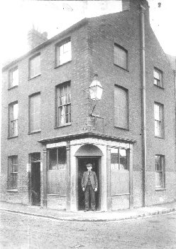 Edward Noble photographed standing in the doorway of the Patent Slip Vaults, Turkey Shore © E. G. Noble